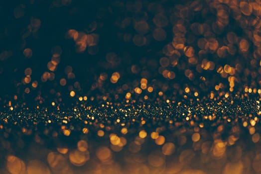 Blur neon gold and blue light circle background. Sparkling firework bokeh dots in vintage style. Luxury and classy new year and christmas celebration party textured dark backdrop. Blurry golden dust.