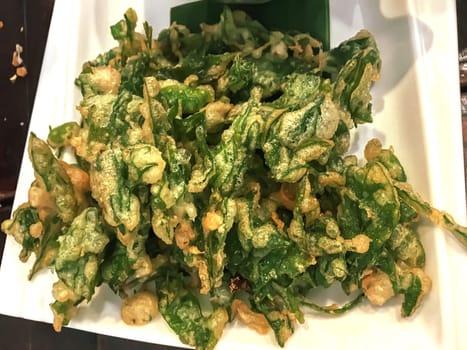 Crispy morning glory salad in a white plate.