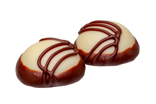 Fine white milk chocolate chocolates decorated with a pattern isolated on a white background. Clipping path. Macro.