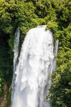 Marmore waterfall in Umbria region, Italy. Amazing cascade splashing into nature with trees and rocks.