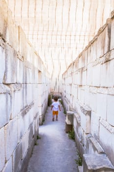 Caucasian young kid walking with labyrinth perspective. Conceptual image for dangerous situation during childhood.