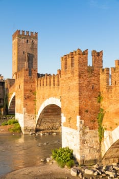 Verona, Italy. Castelvecchio bridge on Adige river. Old castle sightseeing at sunrise