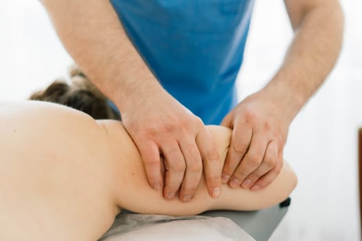 Young fat woman getting massage treatment in a day spa cabinet.