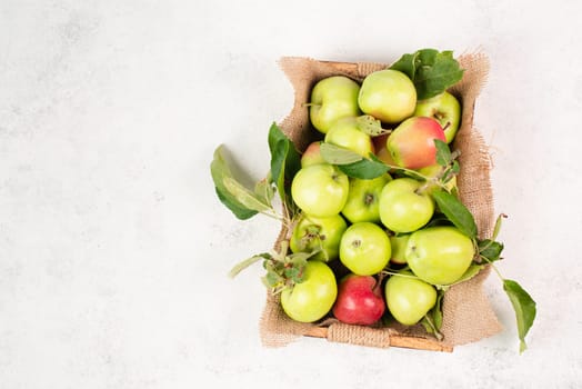 Apples in a basket standing on a table, fruit harvest in the summer, healthy organic food