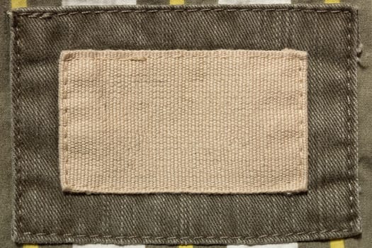 Empty beige fabric patch on men's trousers