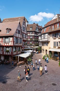 Tourists from all over the world in the picturesque medieval old town of Colmar in France