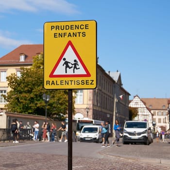 Sign in France with the inscription Prudence Entfants Ralentissez. Translation: caution children, drive slowly