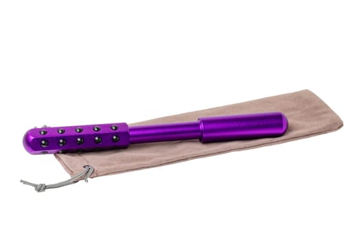 Germanium stone massage roller for face, eyes and body on a beige package. It promotes blood circulation and metabolism. Clipping path. Anti-aging, improving and tightening the skin. Beauty concept.