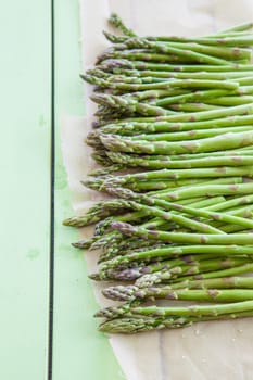 Gruener asparagus on rustic background made of wood