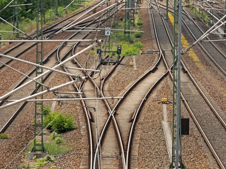 Track systems with overhead lines and switches