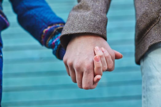 Man and woman holding by hands