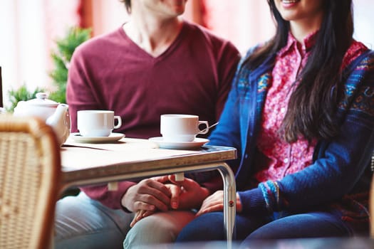 Young couple having rest in cafe by table