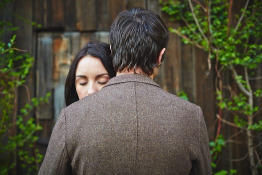 Peaceful woman with closed eyes standing close to her sweetheart