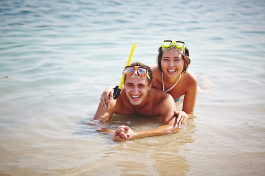 Happy divers looking at camera in water