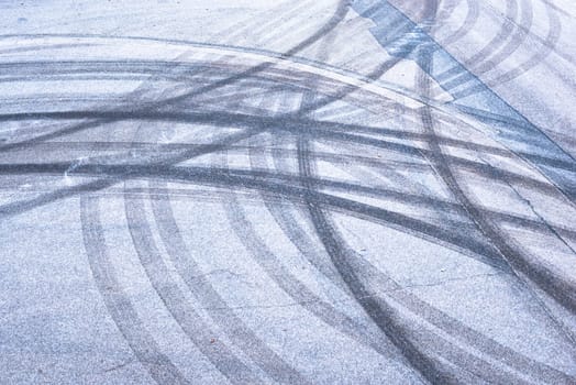 Slippery road, car tracks on the frozen street, black ice in winter