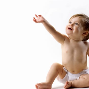 Happy baby in diaper looking and reaching up