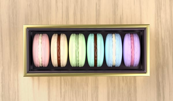 Golden box with french macarons on wooden desk