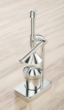 Silver citrus juicer on wooden table