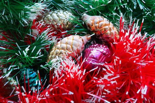 New Year and Christmas decorations, tinsel, boa, Christmas decorations. Multi-colored balls in the form of cones and baskets. Festive interior decoration. New Year or Christmas composition.