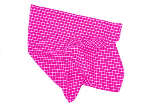 Closeup of a pink and white checkered napkin or tablecloth texture isolated on white background. Kitchen accessories.