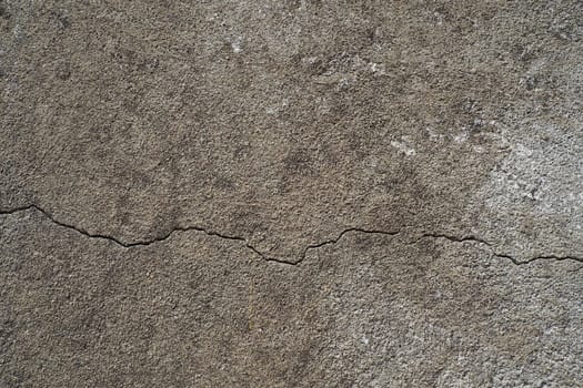 Plastered wall texture. Whitewash surface. Abstract background. Retro wall built structure texture. Cracks and bumps on the concrete wall. Uneven coloring with water-based paint. Old tattered plaster.