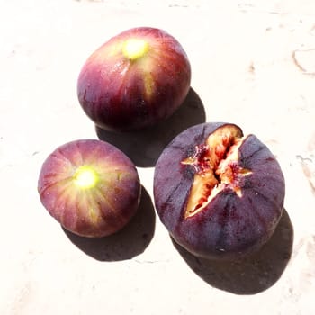 Fig or fig tree, or common fig tree, or Ficus carica is a subtropical deciduous plant of the genus Ficus of the Mulberry family. Ripe purple fig fruits on a light background. Healthy food.