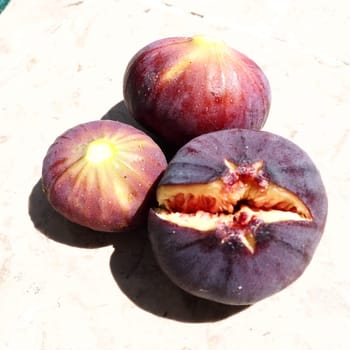 Fig or fig tree, or common fig tree, or Ficus carica is a subtropical deciduous plant of the genus Ficus of the Mulberry family. Ripe purple fig fruits on a light background. Healthy food.