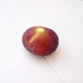 Fig or fig tree, or common fig tree, or Ficus carica is a subtropical deciduous plant of the genus Ficus of the Mulberry family. Ripe purple fig fruits on a light background. Healthy food.