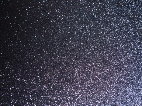 Purple shiny bokeh abstract background. Blue - lilac paper with sparkles. Festive backdrop.