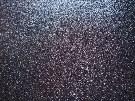 Purple shiny bokeh abstract background. Blue - lilac paper with sparkles. Festive backdrop.