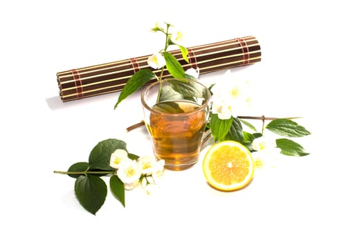 glass of lime tea with a lemon at a rug, a subject drinks
