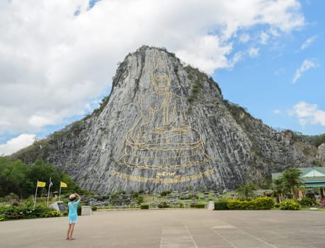 Buddha laser carved and inlayed with gold on the cliff at Khao Chee Chan in Pattaya, Thailand