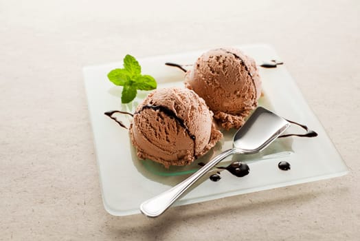 Fresh Chocolate ice cream on a plate close up