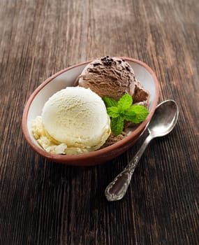 Vanilla and chocolate Ice cream on wooden background