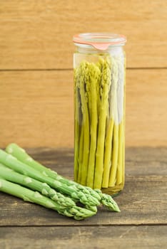 Fresh green asparagus and boiled asparagus in the glass
