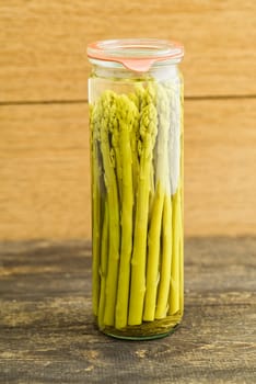 Fresh green asparagus and boiled asparagus in the glass