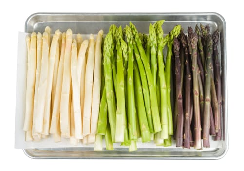 White,green and violet asparagus on baking sheet exposed on white background