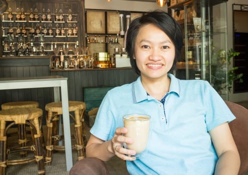 Customer enjoying hot coffee latte, stock photo