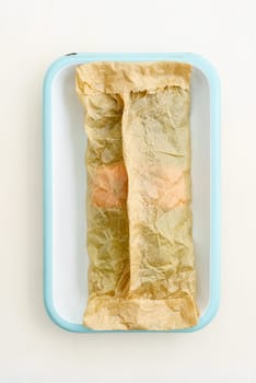 Green asparagus with salmon for baking with baking paper in a baking dish