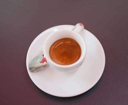 epresso in a white cup with spoon