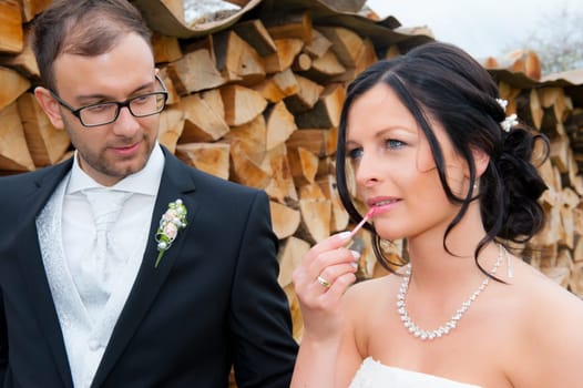 young bridal couple together in front of wooden background