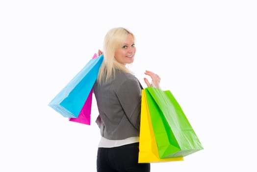 young blond woman in front of white background with shopping bags