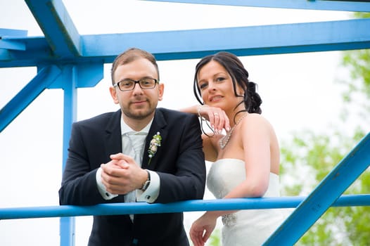 young bridal couple together in front of nature background