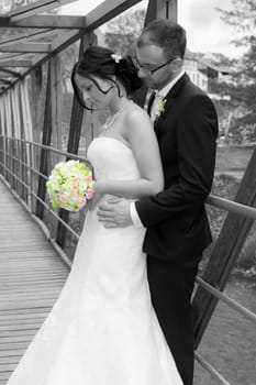 young bridal couple together in front of nature background
