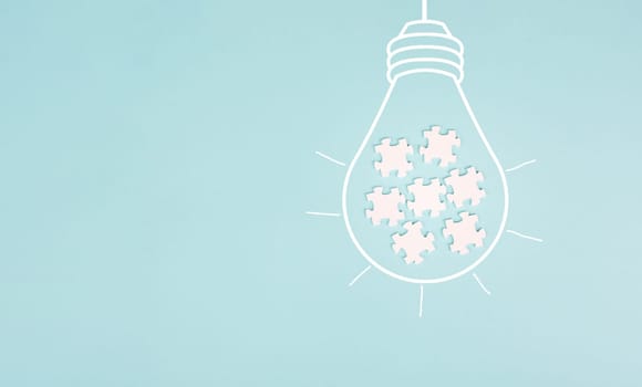 Light bulb with jigsaw or puzzle pieces, brainstorming for ideas, finding solution, solving a problem