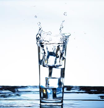 The image of pouring drinking water, into a glass, that makes one feel refreshed on blurred white background, Splashing water, Sparkling water