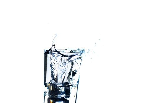 The image of pouring drinking water, into a glass, that makes one feel refreshed on blurred white background, Splashing water, Sparkling water