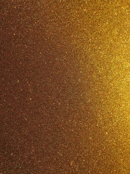 Bokeh light of gold glitters. Golden glitter texture background. Sparkling glitter wrapping paper with sequins and sparkles. Festive golden bokeh and glitter. Beautiful background
