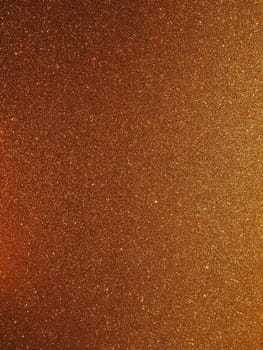 Bokeh light of gold glitters. Golden glitter texture background. Sparkling glitter wrapping paper with sequins and sparkles. Festive golden bokeh and glitter. Beautiful background