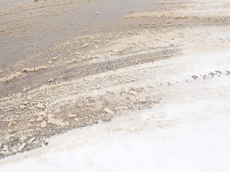 Snowdrifts on the side of the road. Bad weather and traffic. Snow on asphalt. Difficult driving conditions. Winter slosh on the road. Braking distance of a car